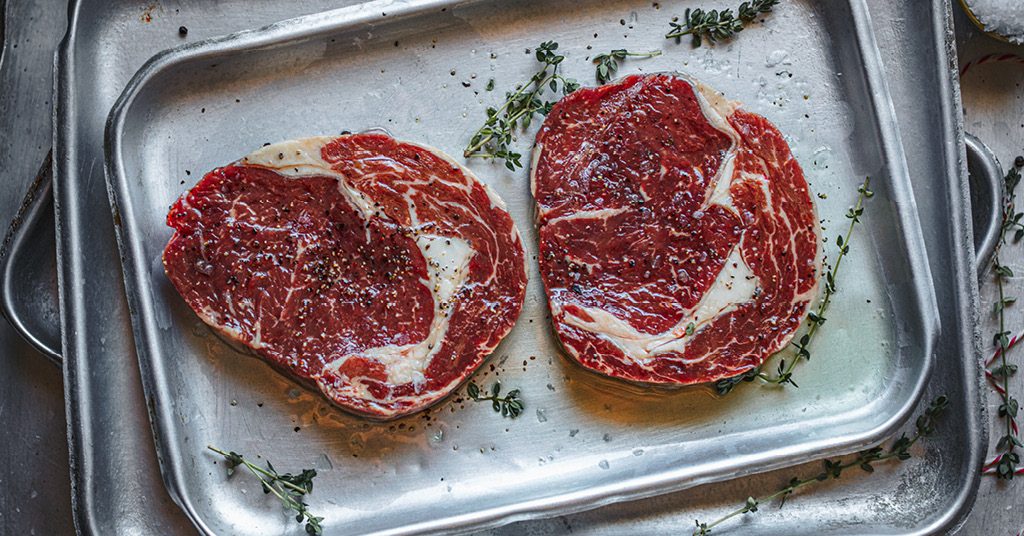 Two steaks on a pan with thyme | Beachside Grill Saunton