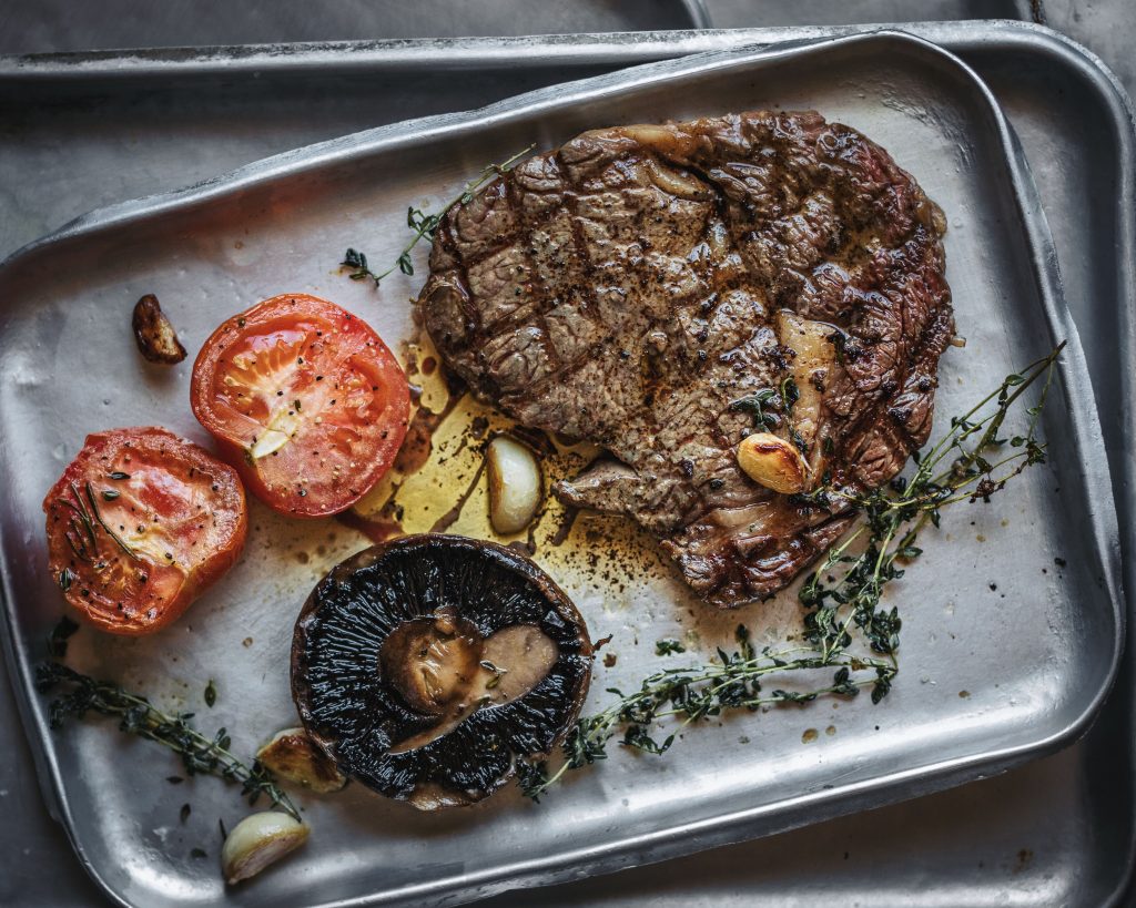 grilled steak with tomatoes and mushrooms